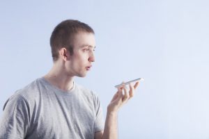 Man using voice command on his smartphone