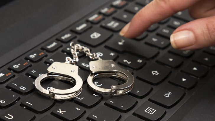 small handcuffs on computer keyboard