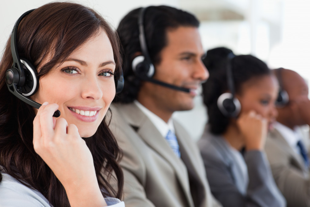 Customer service executives on calls with customers