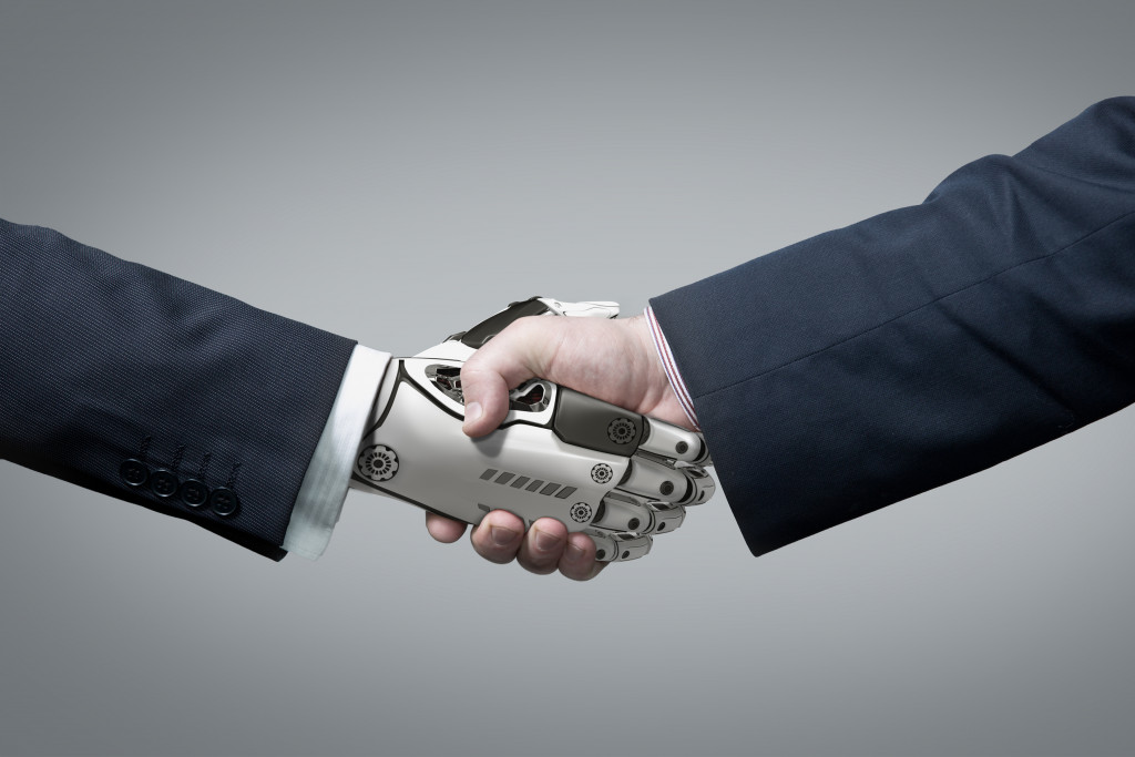 robot hand shaking hands with human hands